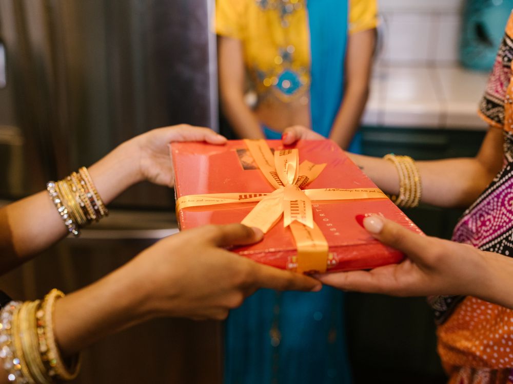 Two people exchanging a gift